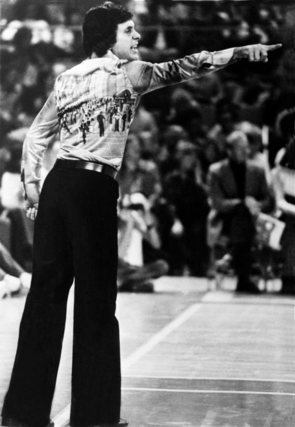 Larry Brown talks with his team