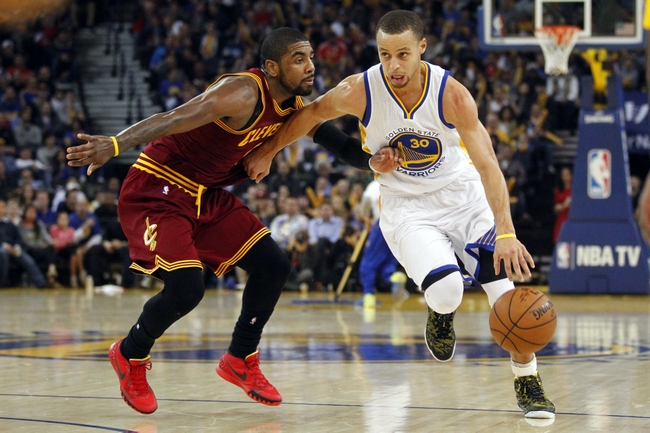 Jan 9, 2015; Oakland, CA, USA; Golden State Warriors guard Stephen Curry (30) drives past Cleveland Cavaliers guard Kyrie Irving (2) in the third quarter at Oracle Arena. The Warriors defeated the Cavaliers 112-94. Mandatory Credit: Cary Edmondson-USA TODAY Sports