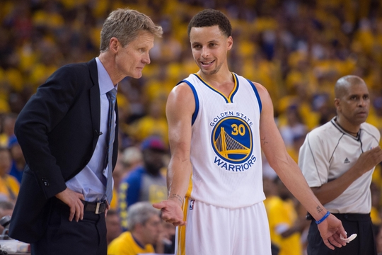 April 18, 2015; Oakland, CA, USA; Golden State Warriors guard Stephen Curry (30) talks to head coach Steve Kerr (left) during the fourth quarter in game one of the first round of the NBA Playoffs against the New Orleans Pelicans at Oracle Arena. The Warriors defeated the Pelicans 106-99. Mandatory Credit: Kyle Terada-USA TODAY Sports