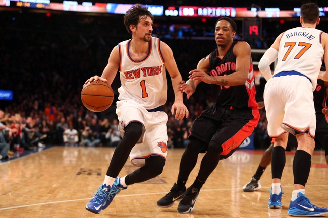 Feb 28, 2015; New York, NY, USA; New York Knicks point guard Alexey Shved (1) drives against Toronto Raptors shooting guard DeMar DeRozan (10) during the second half at Madison Square Garden. Mandatory Credit: Brad Penner-USA TODAY Sports