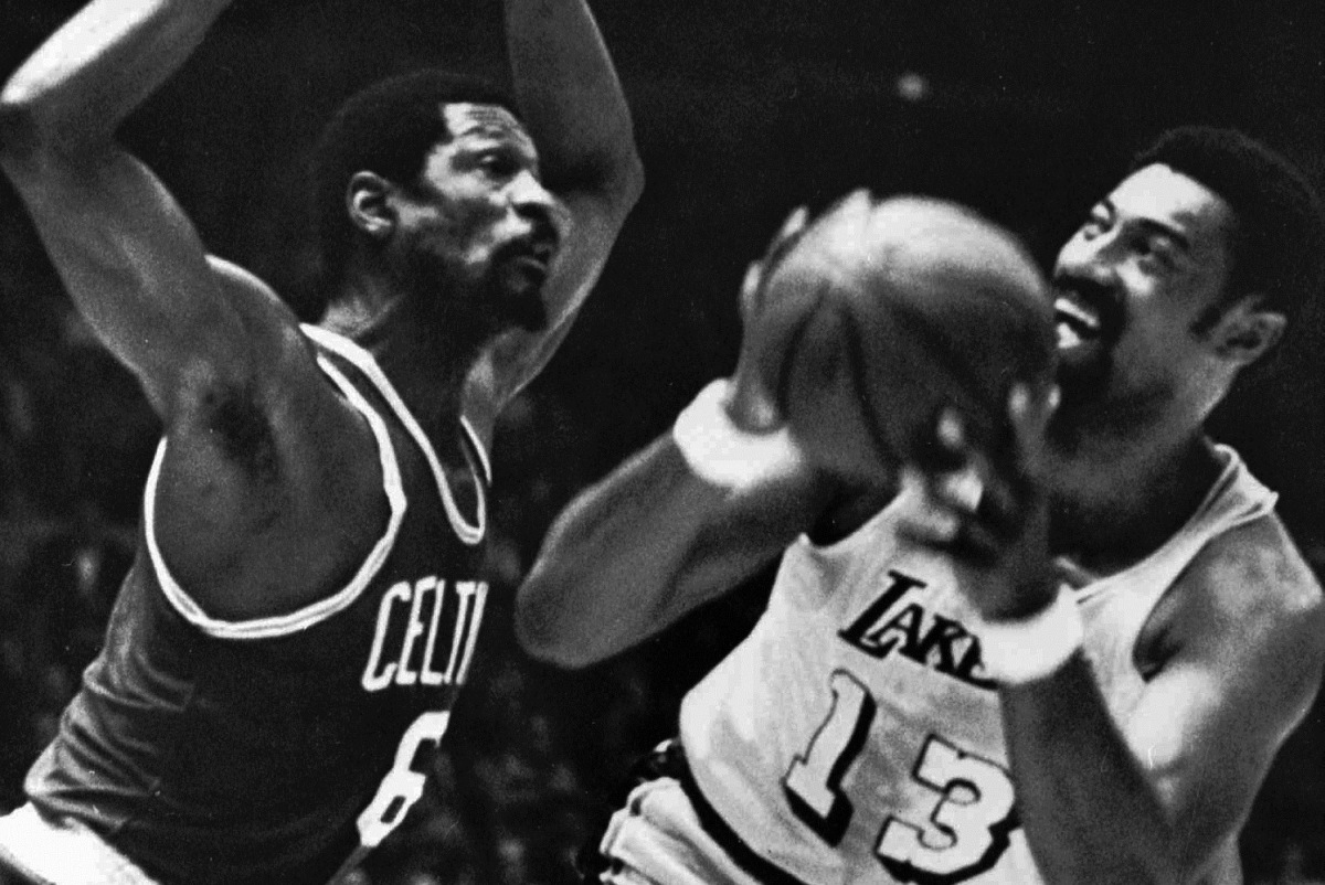 ** FILE ** In this May 5, 1969, file photo, Los Angeles Lakers' Wilt Chamberlain tries to shoot against Boston Celtics' Bill Russell during an NBA basketball finals game at the Forum in Los Angeles. The Celtics and the Lakers met 10 times in the finals from 1959-87, with the Celtics winning the first eight. From 1983-87 alone, they played nearly 30 games, counting playoffs. (AP Photo/File) ORG XMIT: NY167
