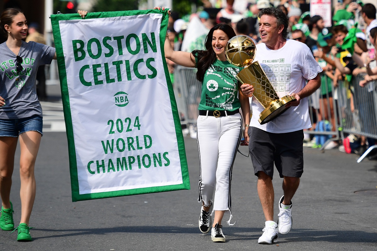 La bannière de champions 2024 des Boston Celtics portée par le propriétaire de la franchise, Wyc Grousbeck